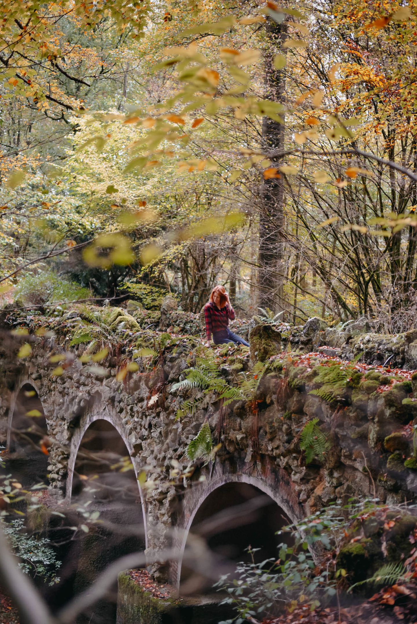 Girls sitting on a stone bridge near Château de la Hulpe Brussels