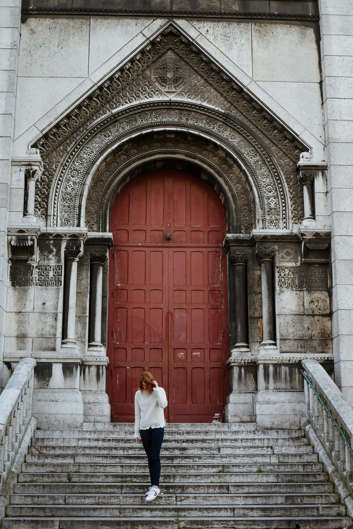 girl in front of door from sacre coeur in paris